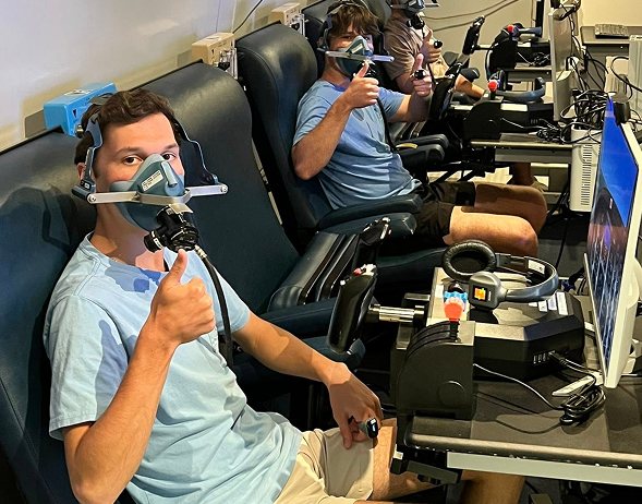 Trainee on oxygen at a flight-sim station inside the chamber