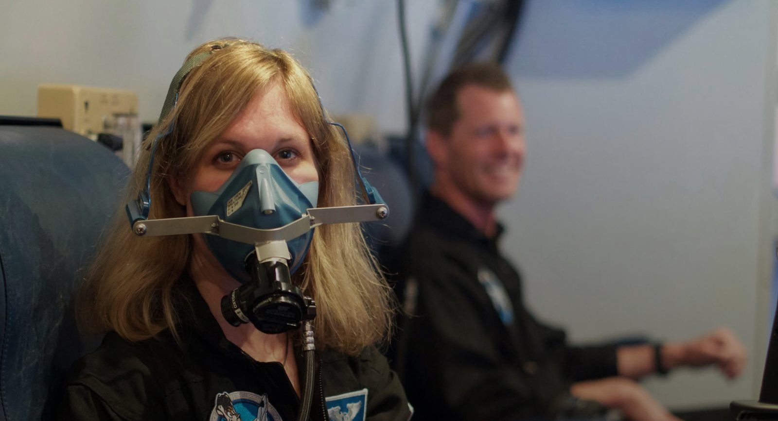 Trainee wearing an oxygen mask during a chamber session